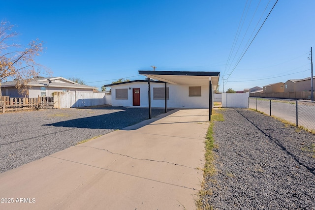 view of front of house featuring an attached carport, a gate, driveway, and fence