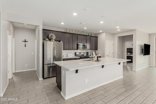 12357 W Whyman Ave, Avondale, AZ 85323 - kitchen featuring appliances with stainless steel finishes, recessed lighting, baseboards, a sink, and dark brown cabinetry