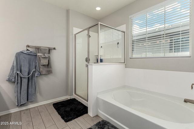 12357 W Whyman Ave, Avondale, AZ 85323 - bathroom with a stall shower, a bath, wood tiled floors, baseboards, and recessed lighting