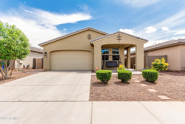 12357 W Whyman Ave, Avondale, AZ 85323 - mediterranean / spanish house featuring driveway, a garage, stucco siding, fence, and a tile roof