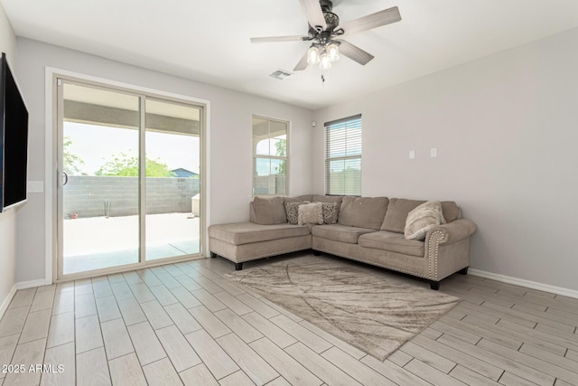 12357 W Whyman Ave, Avondale, AZ 85323 - living room with a ceiling fan, light wood-style flooring, and baseboards