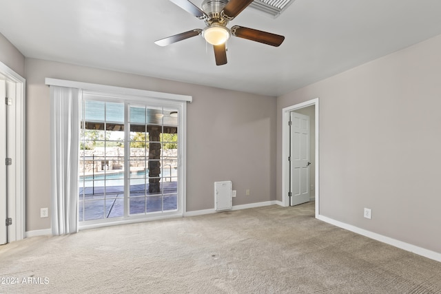 carpeted empty room featuring ceiling fan