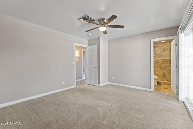 unfurnished bedroom with light carpet, connected bathroom, and ceiling fan