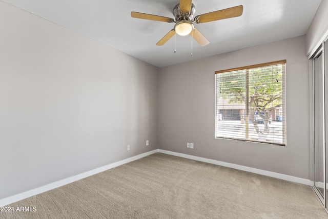 spare room with light carpet and ceiling fan