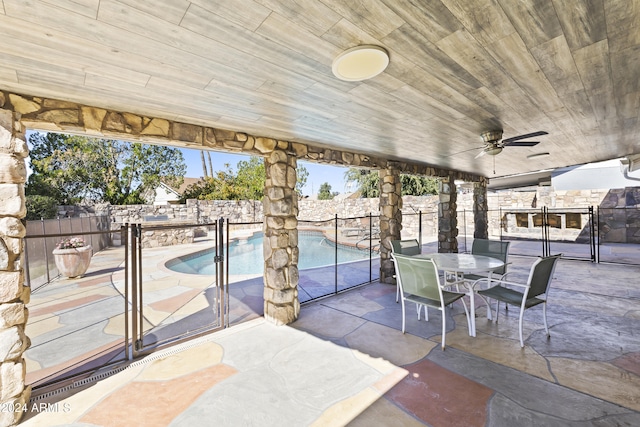 view of patio / terrace featuring ceiling fan and a fenced in pool