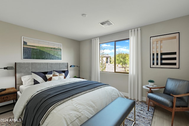 bedroom with hardwood / wood-style floors