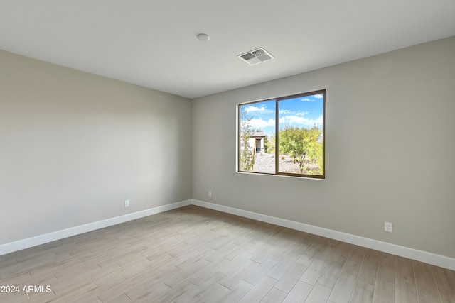 empty room with light hardwood / wood-style flooring