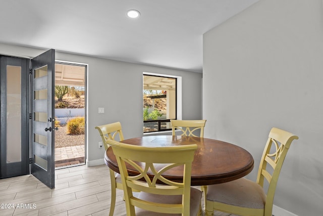 dining area with french doors and light hardwood / wood-style flooring