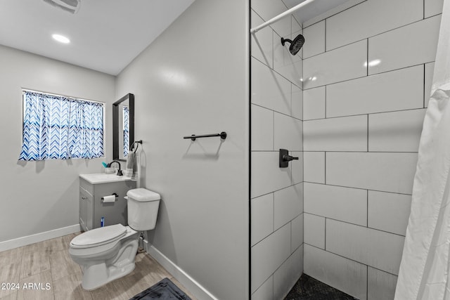 bathroom with wood-type flooring, vanity, toilet, and a shower with curtain