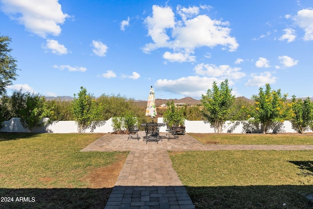 view of yard featuring a mountain view and a patio area