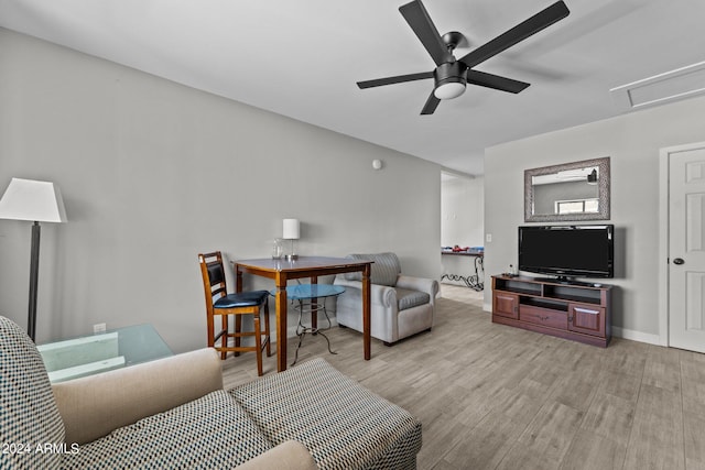 living room with ceiling fan and light wood-type flooring