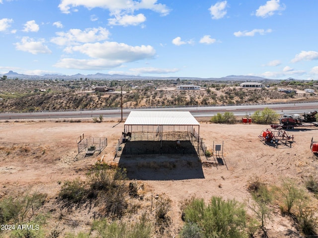 entry to storm shelter with a mountain view and an outbuilding