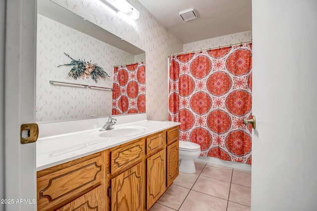 bathroom with vanity, toilet, and tile patterned flooring