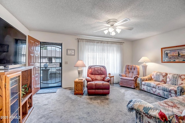 living room with a healthy amount of sunlight, ceiling fan, and carpet flooring