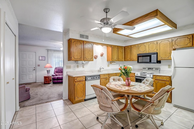 kitchen with ceiling fan, white appliances, sink, and light tile patterned floors