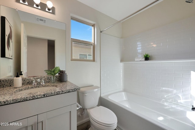 full bathroom featuring vanity, bathtub / shower combination, and toilet