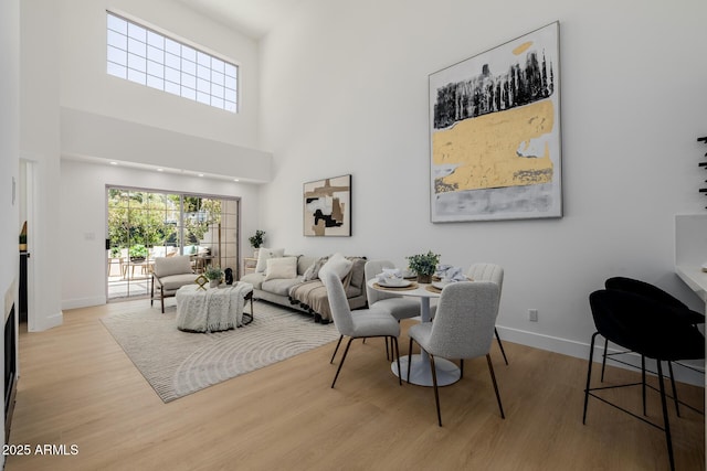 7710 E Gainey Ranch Rd E Unit 115, Scottsdale, AZ 85258 - living area with wood finished floors and a towering ceiling