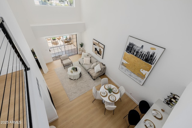 7710 E Gainey Ranch Rd E Unit 115, Scottsdale, AZ 85258 - living area featuring a high ceiling, wood finished floors, an office area, and stairway