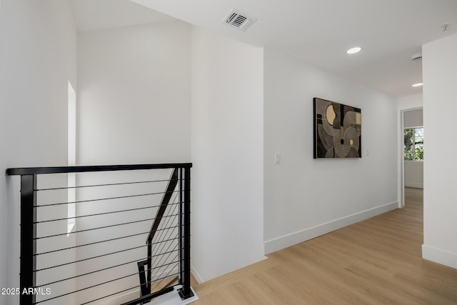 7710 E Gainey Ranch Rd E Unit 115, Scottsdale, AZ 85258 - corridor with an upstairs landing, wood finished floors, and recessed lighting