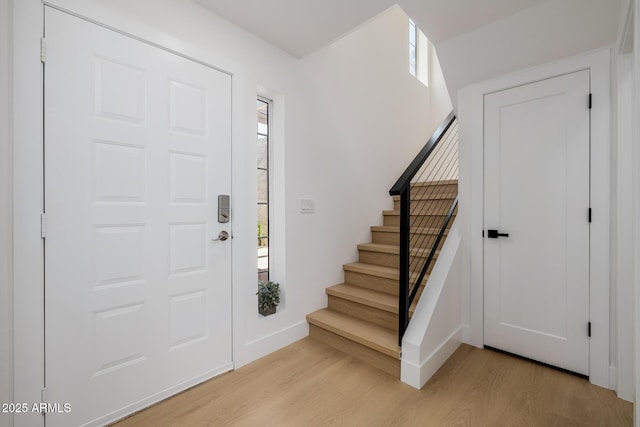 7710 E Gainey Ranch Rd E Unit 115, Scottsdale, AZ 85258 - entryway featuring light wood-type flooring, plenty of natural light, and stairs