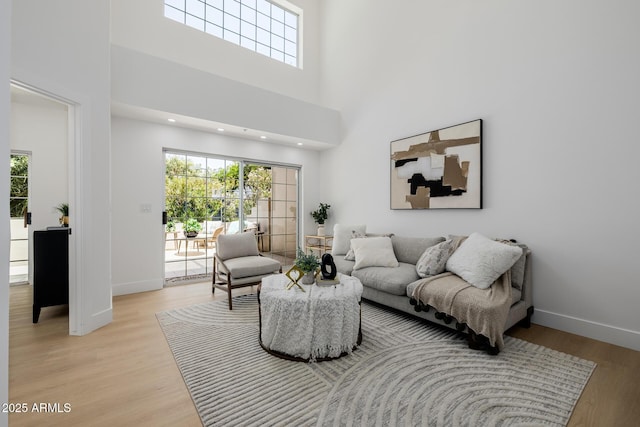 7710 E Gainey Ranch Rd E Unit 115, Scottsdale, AZ 85258 - living area with healthy amount of natural light, light wood-style floors, and a towering ceiling