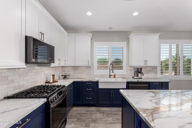 40913 W Williams Way, Maricopa, AZ 85138 - kitchen featuring range with gas cooktop, black microwave, blue cabinets, white cabinets, and recessed lighting