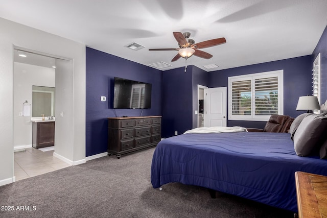 40913 W Williams Way, Maricopa, AZ 85138 - carpeted bedroom with connected bathroom, a ceiling fan, and tile patterned floors