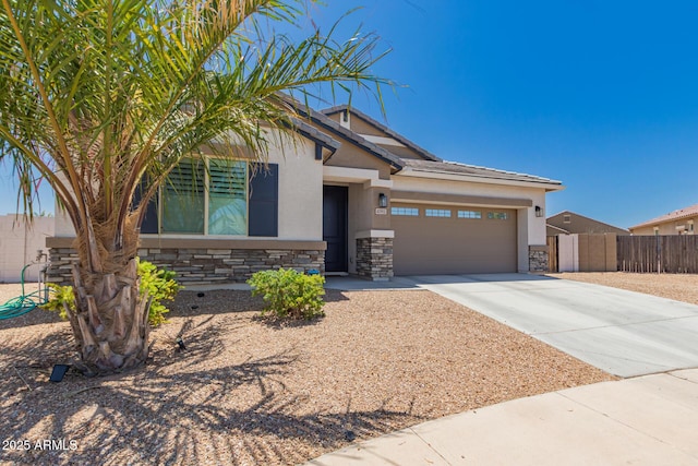 40913 W Williams Way, Maricopa, AZ 85138 - view of front of house with stone siding, a garage, concrete driveway, and stucco siding