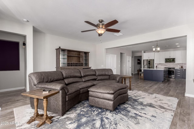 40913 W Williams Way, Maricopa, AZ 85138 - living room featuring ceiling fan, wood finished floors, and a chandelier