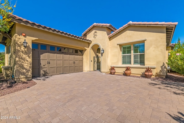 mediterranean / spanish house with a garage