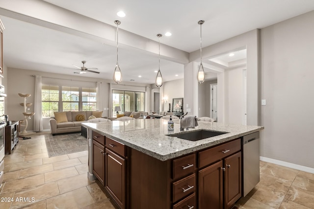 kitchen with light stone countertops, ceiling fan, a center island with sink, dishwasher, and hanging light fixtures