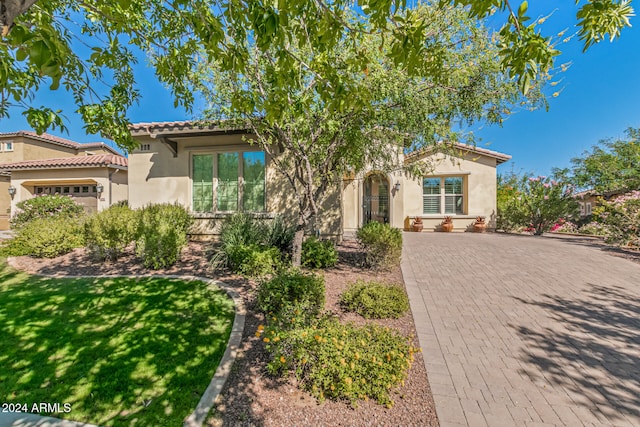 mediterranean / spanish home with a garage