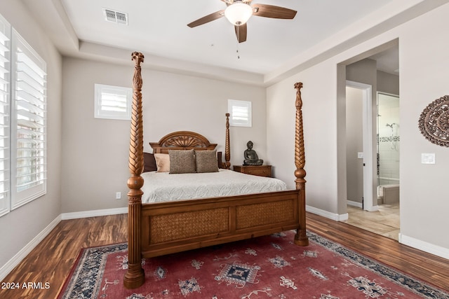 bedroom with hardwood / wood-style flooring, ceiling fan, and connected bathroom