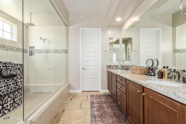 bathroom with vanity and a tile shower