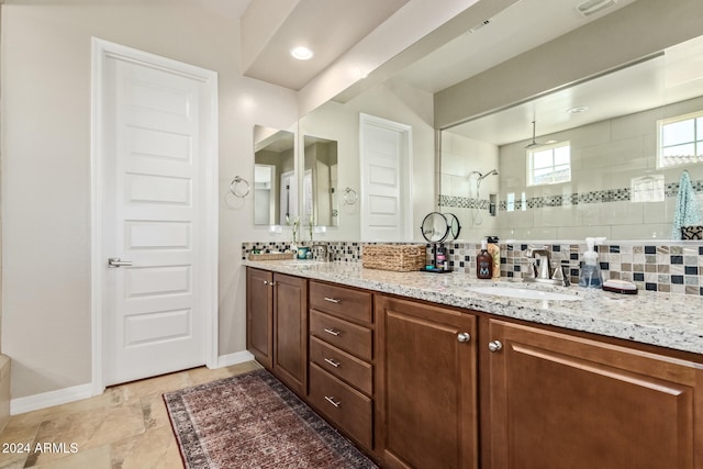 bathroom featuring backsplash, vanity, and tiled shower