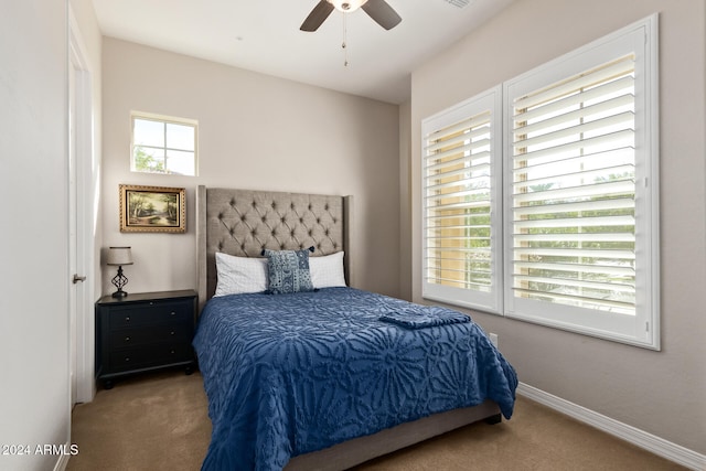 bedroom featuring ceiling fan, carpet floors, and multiple windows