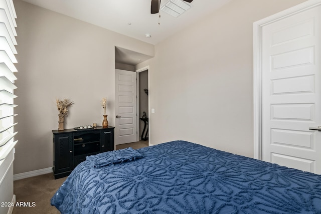 bedroom with dark carpet and ceiling fan