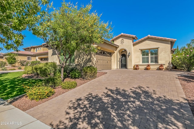 mediterranean / spanish-style home featuring a garage