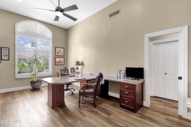 office with ceiling fan, visible vents, baseboards, and wood finished floors