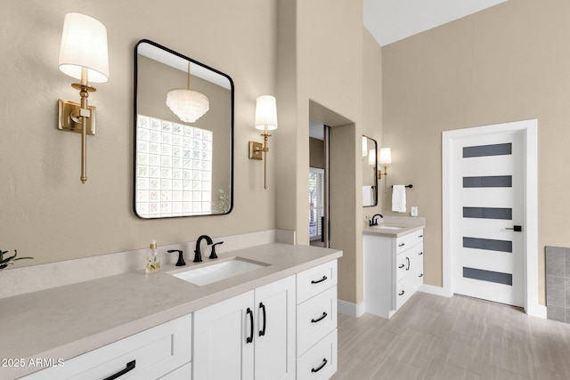 bathroom with a sink and two vanities