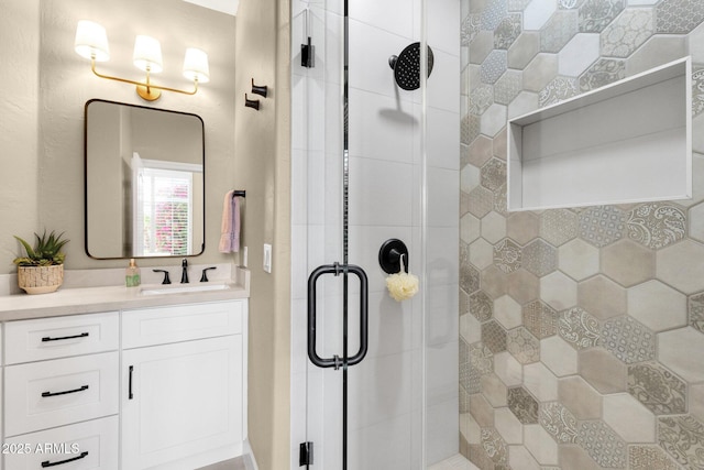 bathroom featuring vanity and a stall shower