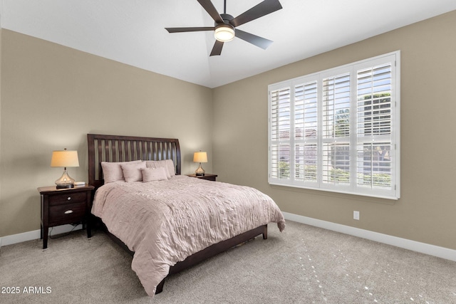 carpeted bedroom with lofted ceiling, multiple windows, and baseboards