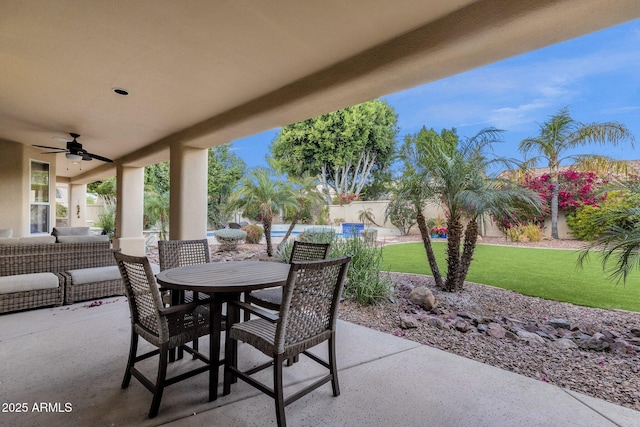 view of patio featuring ceiling fan, outdoor dining area, and a fenced backyard