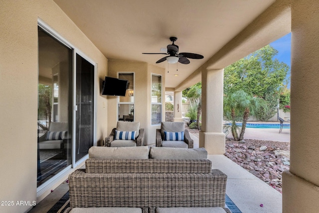 view of patio / terrace featuring an outdoor pool, outdoor lounge area, and a ceiling fan