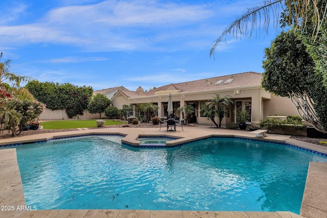 view of pool with a pool with connected hot tub, a patio, and a diving board