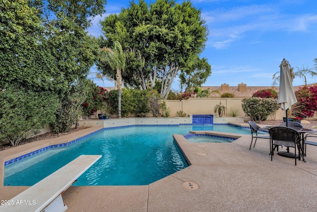 view of swimming pool featuring an in ground hot tub, a fenced in pool, a fenced backyard, and a patio