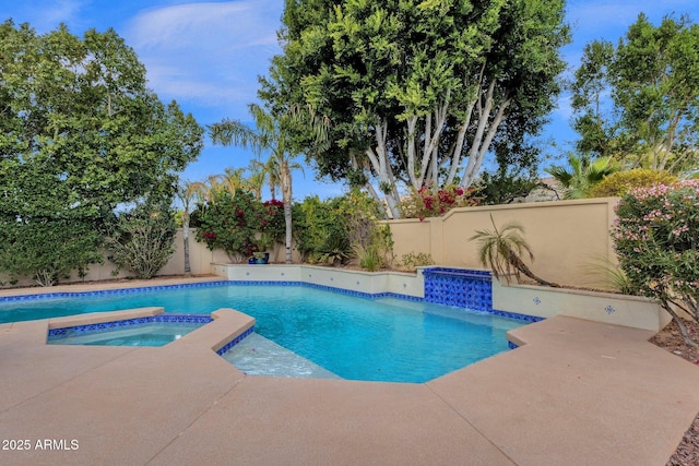 view of swimming pool with an in ground hot tub, a fenced in pool, a fenced backyard, and a patio area