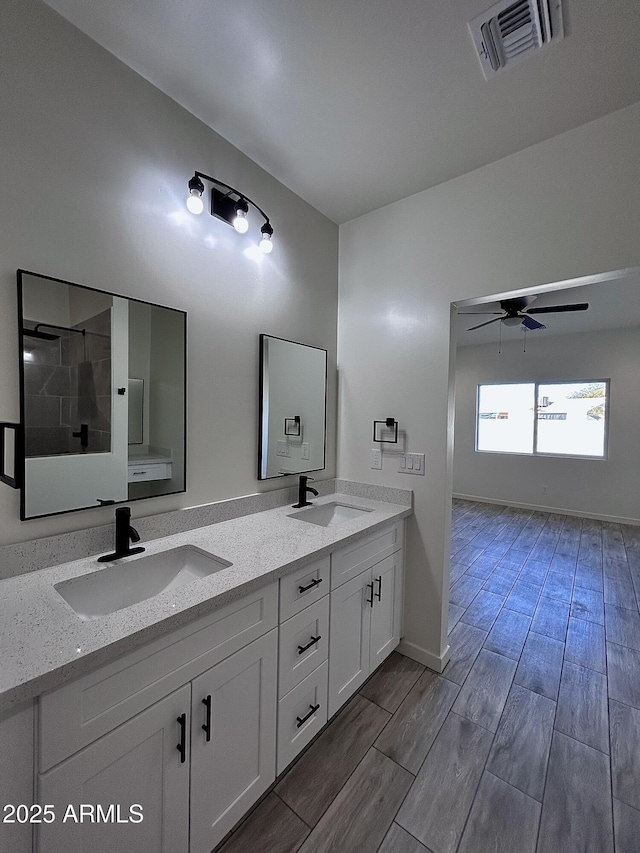 bathroom with ceiling fan, a shower, and vanity