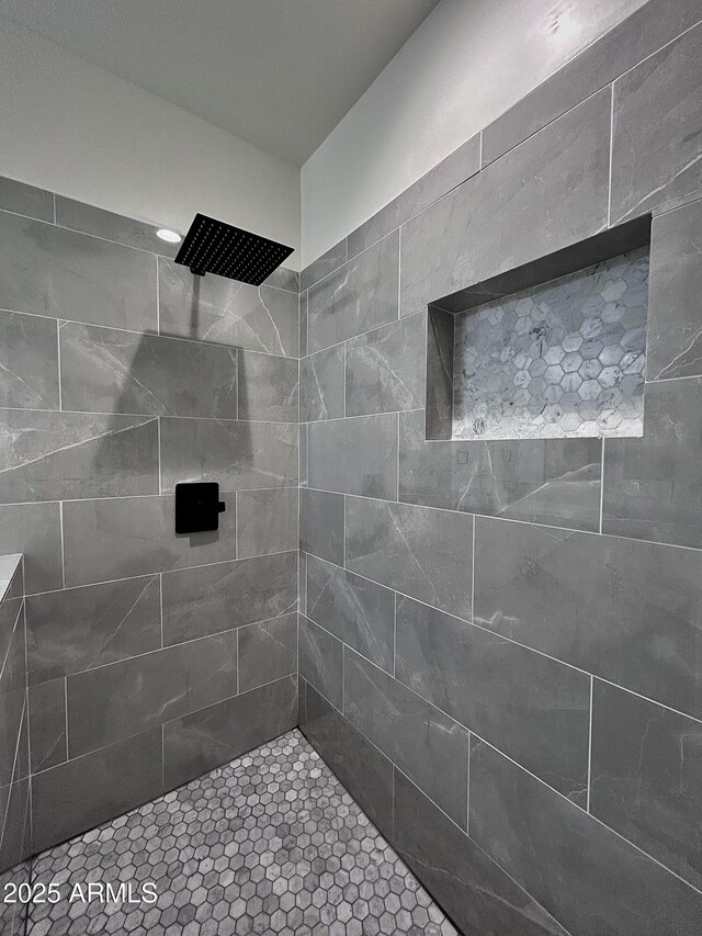 bathroom with tiled shower