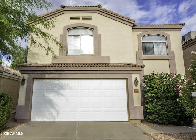 20221 N 31st St, Phoenix, AZ 85050 - mediterranean / spanish house featuring a garage, a tile roof, driveway, and stucco siding